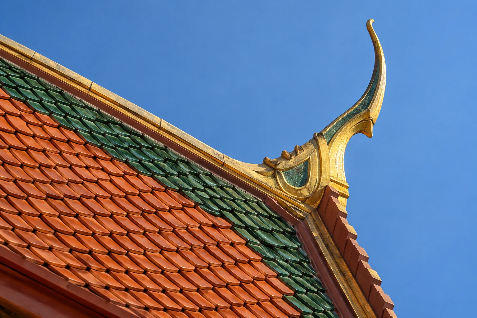 Close view of decorative roof tiles on an imagined Thai temple-inspired building against a clear sky.